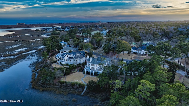 aerial view at dusk with a water view