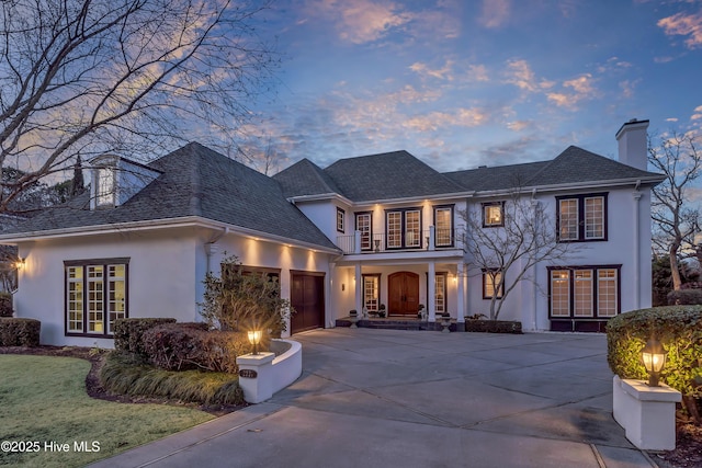 view of front of property with a balcony and a garage