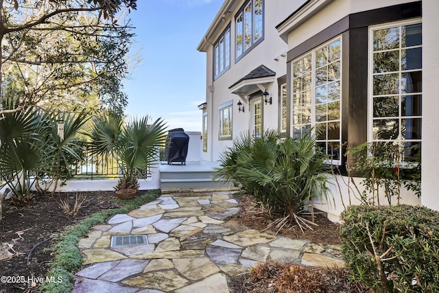 view of exterior entry featuring a patio