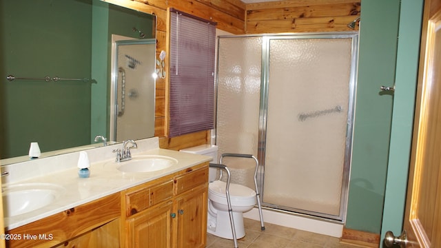 bathroom with vanity, tile patterned floors, toilet, and walk in shower