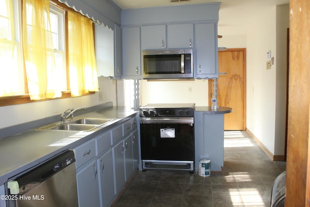 kitchen with stainless steel appliances, a healthy amount of sunlight, and sink