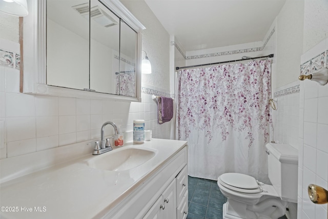 bathroom featuring walk in shower, toilet, tasteful backsplash, tile walls, and vanity