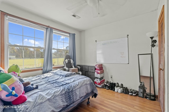 bedroom with wood-type flooring and ceiling fan