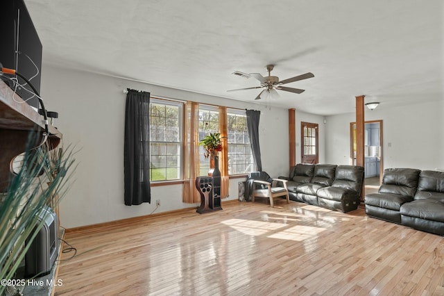 living room featuring light hardwood / wood-style flooring and ceiling fan