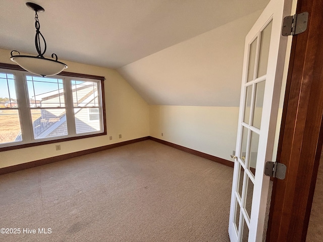 bonus room with lofted ceiling and carpet flooring