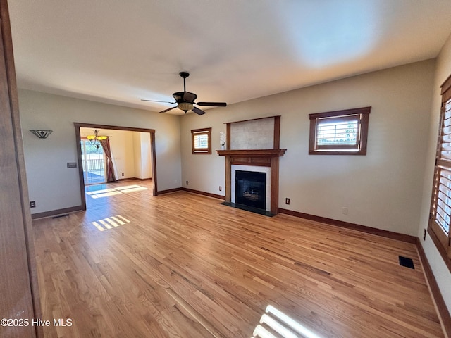 unfurnished living room with ceiling fan and light hardwood / wood-style floors