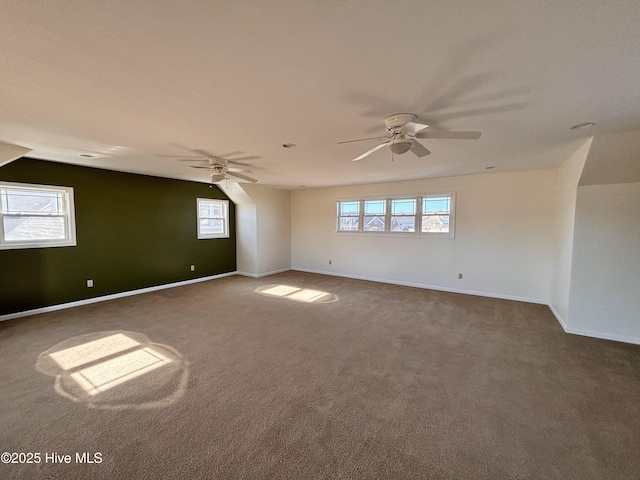 empty room with dark carpet and ceiling fan