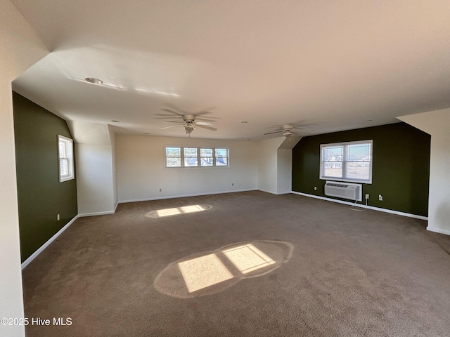 empty room featuring a wealth of natural light, an AC wall unit, and carpet flooring