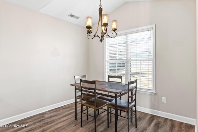 dining area featuring lofted ceiling, a notable chandelier, and dark hardwood / wood-style flooring