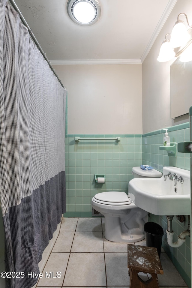 bathroom featuring sink, tile walls, tile patterned flooring, ornamental molding, and toilet