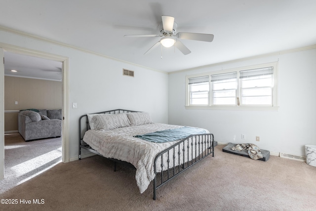 carpeted bedroom with ornamental molding and ceiling fan