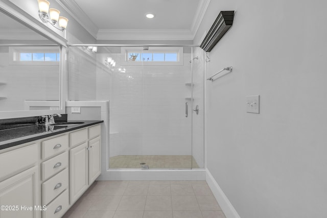 bathroom with vanity, a shower with door, ornamental molding, and a healthy amount of sunlight