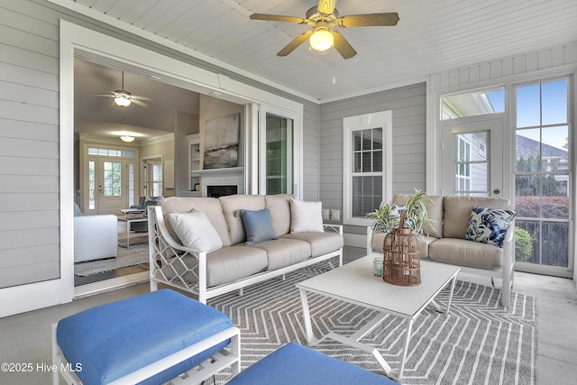 sunroom / solarium featuring a wealth of natural light and ceiling fan