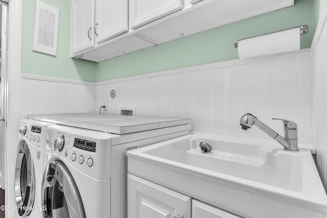 laundry area with cabinets, sink, and washing machine and clothes dryer