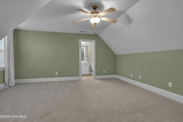 bonus room featuring lofted ceiling, light colored carpet, and ceiling fan