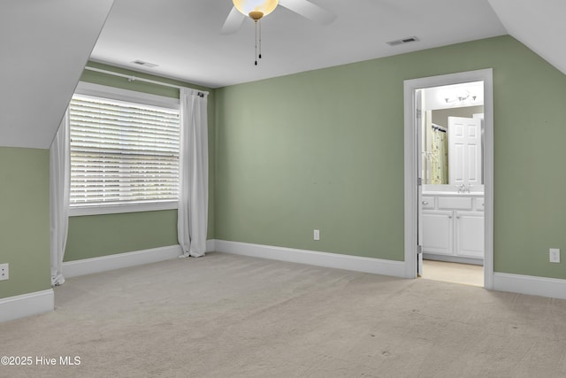 carpeted empty room featuring ceiling fan and lofted ceiling