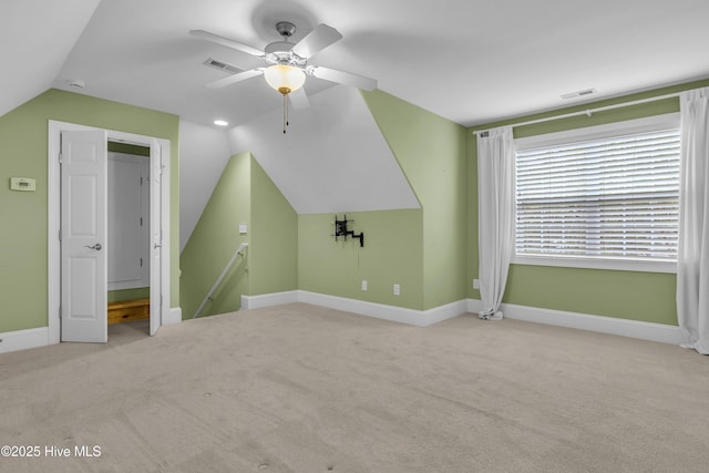 bonus room with ceiling fan, lofted ceiling, and light carpet