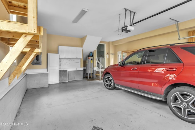 garage with a garage door opener, electric panel, and water heater