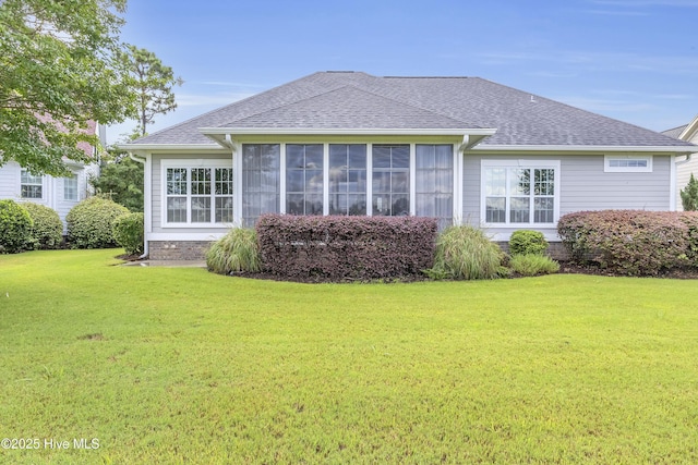 rear view of house with a yard