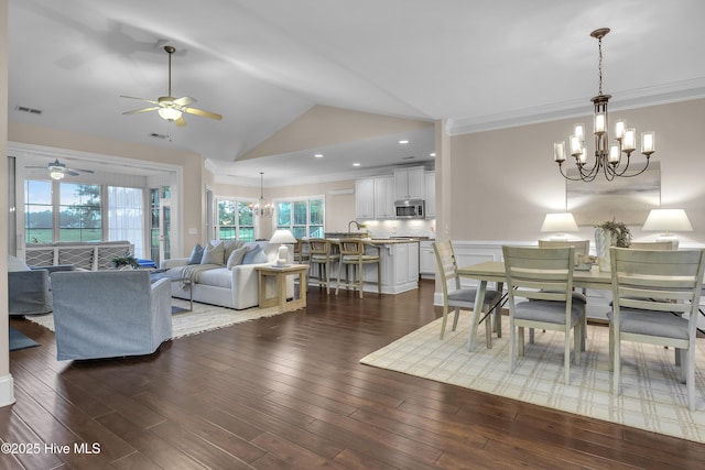 dining area with an inviting chandelier, dark wood-type flooring, and ornamental molding