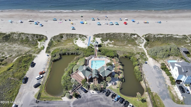 birds eye view of property with a view of the beach and a water view