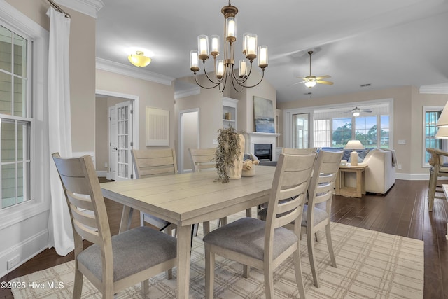 dining area with lofted ceiling, crown molding, and dark wood-type flooring