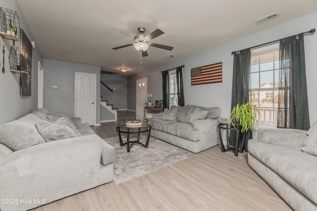 living room with ceiling fan and light hardwood / wood-style floors