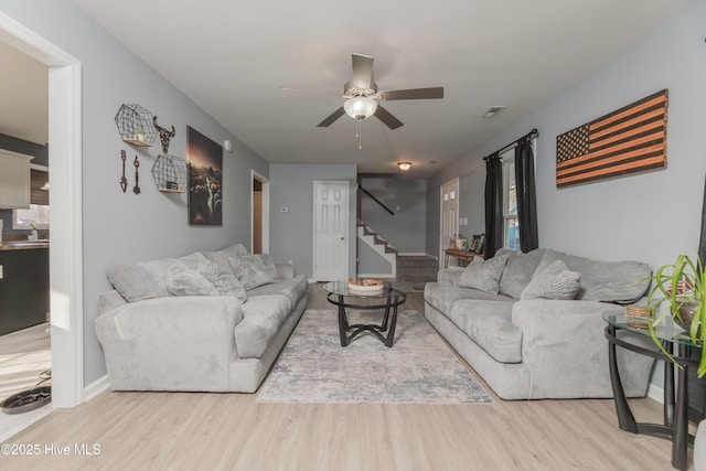 living room with ceiling fan and light wood-type flooring