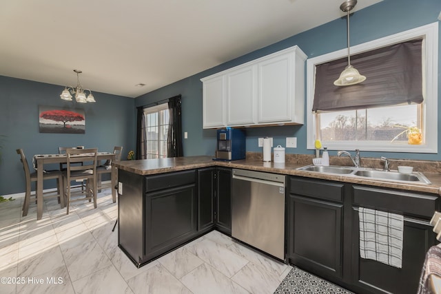 kitchen with white cabinetry, sink, decorative light fixtures, and dishwasher