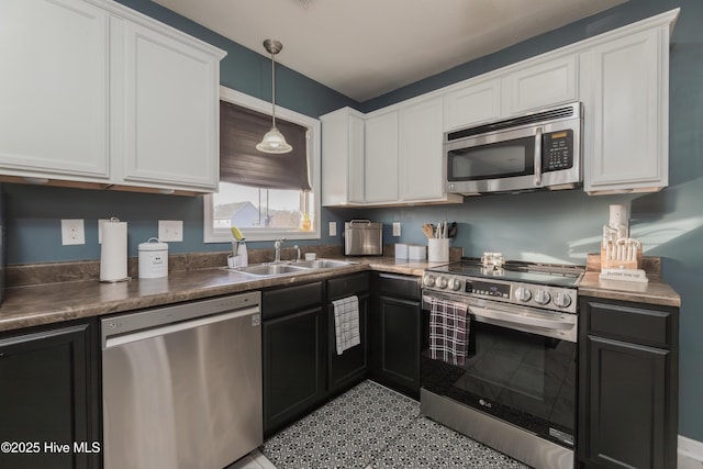 kitchen with white cabinetry, sink, decorative light fixtures, and appliances with stainless steel finishes