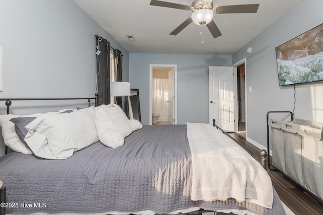 bedroom featuring dark wood-type flooring, connected bathroom, and ceiling fan