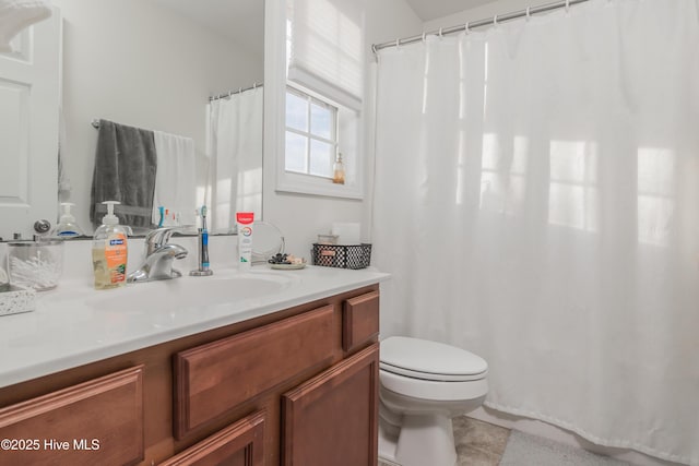 bathroom featuring vanity, tile patterned flooring, and toilet