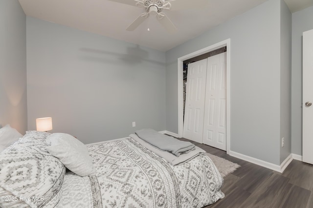 bedroom with a closet, dark hardwood / wood-style floors, and ceiling fan