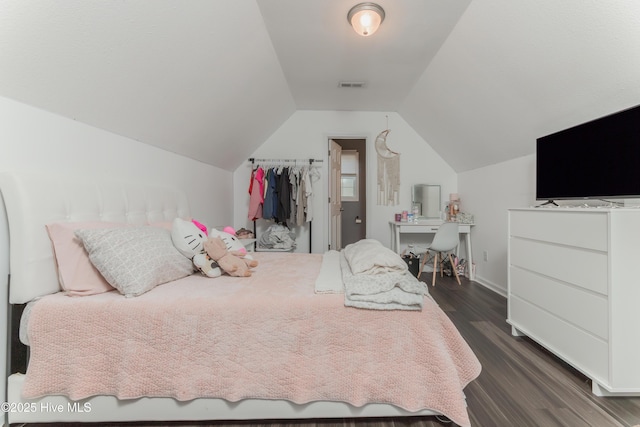 bedroom featuring dark hardwood / wood-style flooring and vaulted ceiling