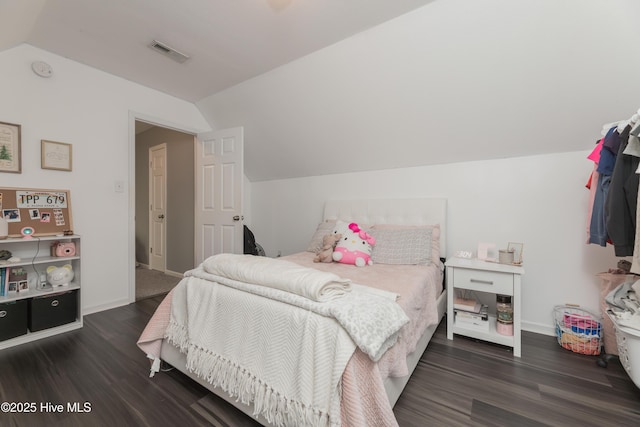 bedroom with lofted ceiling and dark wood-type flooring