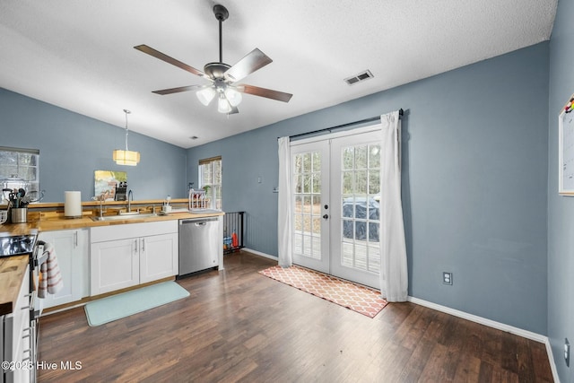 kitchen with wood counters, sink, decorative light fixtures, appliances with stainless steel finishes, and white cabinets