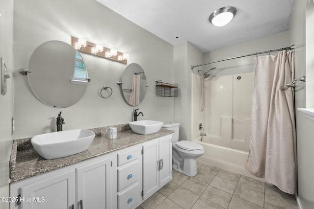 full bathroom featuring tile patterned floors, toilet, a textured ceiling, vanity, and shower / bath combo