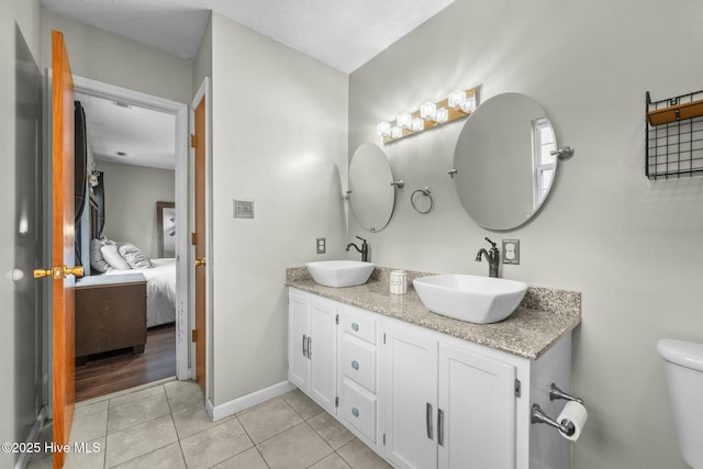 bathroom featuring tile patterned floors, toilet, and vanity