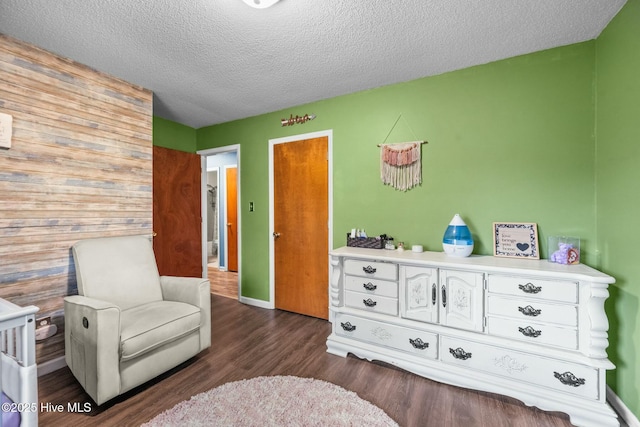 sitting room with dark hardwood / wood-style flooring and a textured ceiling