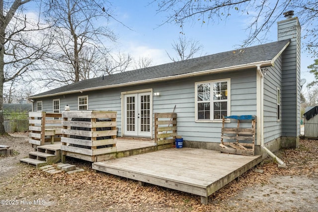 rear view of property with a deck and french doors