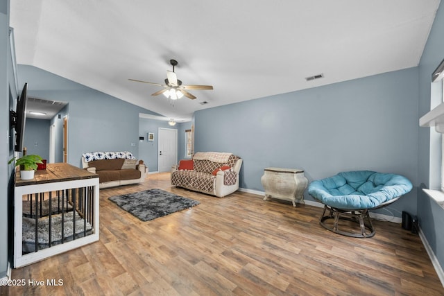 living room with ceiling fan, lofted ceiling, and hardwood / wood-style floors