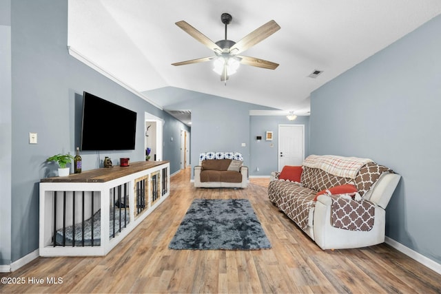 living room with hardwood / wood-style flooring, vaulted ceiling, and ceiling fan