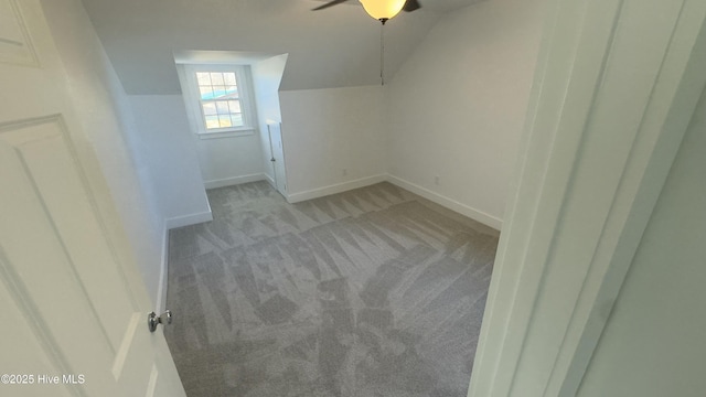 bonus room featuring light colored carpet and vaulted ceiling