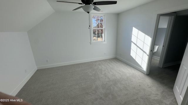 additional living space with light carpet, vaulted ceiling, and ceiling fan