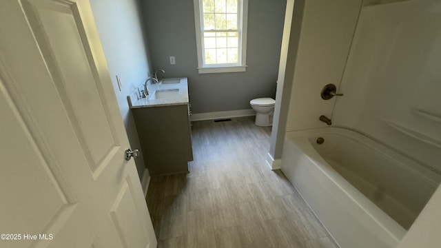 bathroom featuring vanity, hardwood / wood-style flooring, and toilet