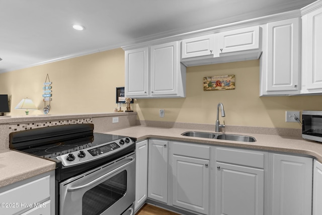 kitchen with crown molding, appliances with stainless steel finishes, sink, and white cabinets