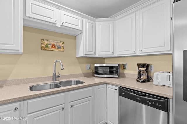 kitchen with white cabinetry, appliances with stainless steel finishes, and sink