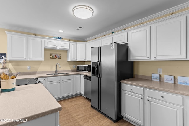 kitchen featuring sink, crown molding, light hardwood / wood-style flooring, stainless steel appliances, and white cabinets