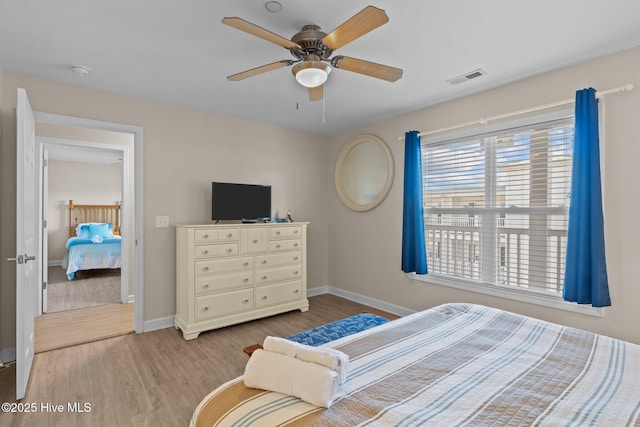 bedroom with light hardwood / wood-style flooring and ceiling fan