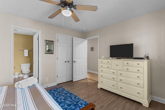 bedroom featuring hardwood / wood-style floors, a closet, ceiling fan, and ensuite bathroom